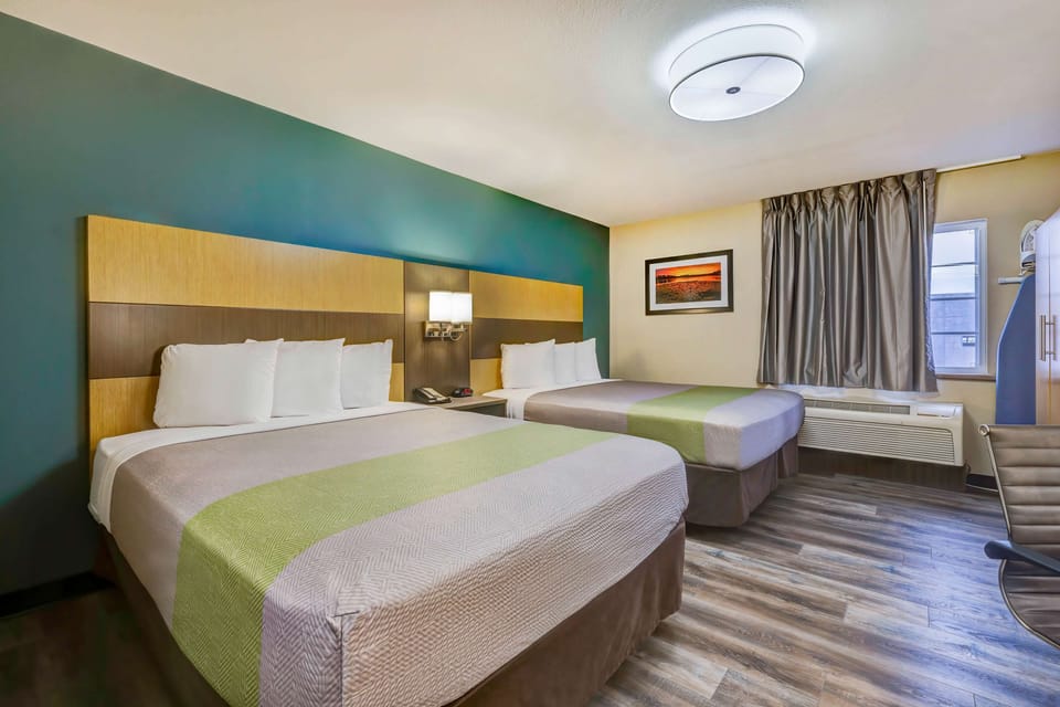 Desk, laptop workspace, blackout drapes, iron/ironing board