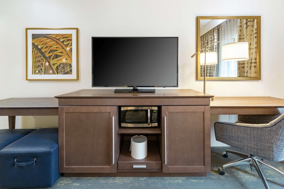 Premium bedding, desk, laptop workspace, blackout drapes