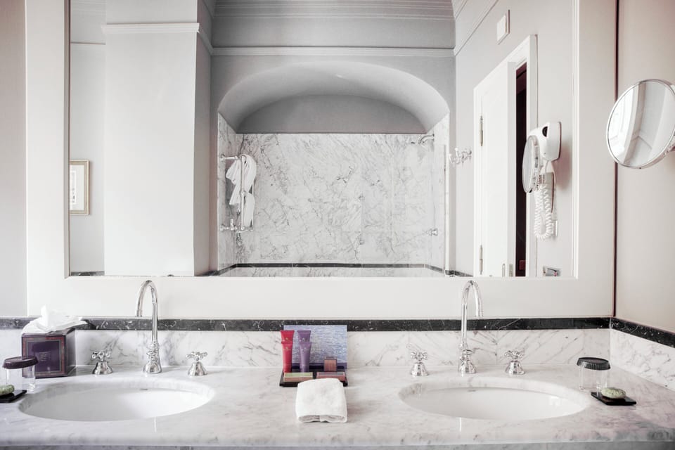 Deluxe Suite | Bathroom | Designer toiletries, hair dryer, bathrobes, slippers