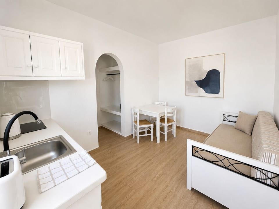 Basic Triple Room, 1 Bedroom | Living area | Flat-screen TV