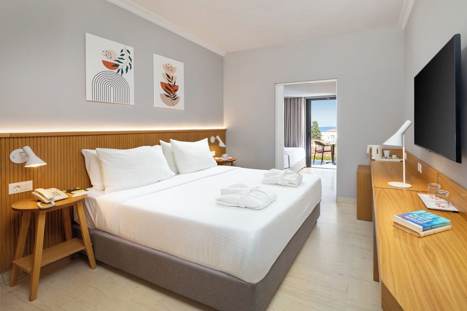 Family Room, Sea View | Minibar (free items), in-room safe, desk, blackout drapes