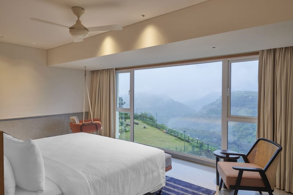 Kune Falls Suite | Minibar, in-room safe, desk, blackout drapes