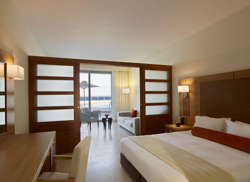 Deluxe Room, Pool Access, Sea View | Premium bedding, in-room safe, laptop workspace, blackout drapes