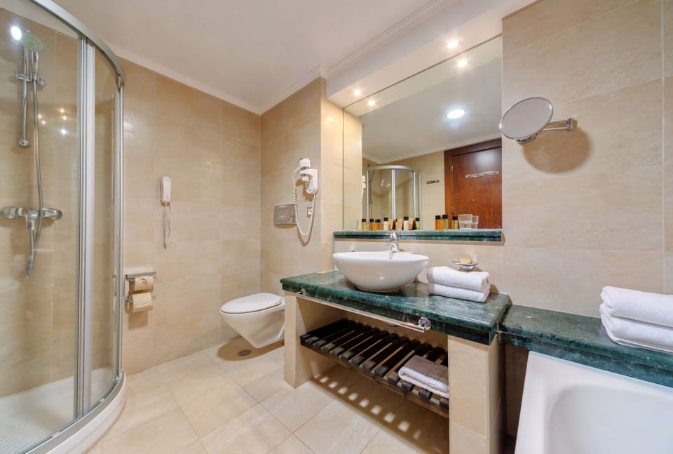 Separate tub and shower, rainfall showerhead, free toiletries