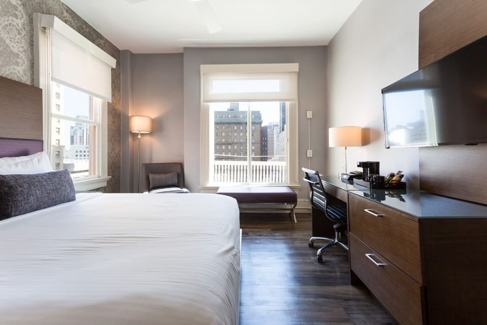 Premium bedding, desk, laptop workspace, blackout drapes