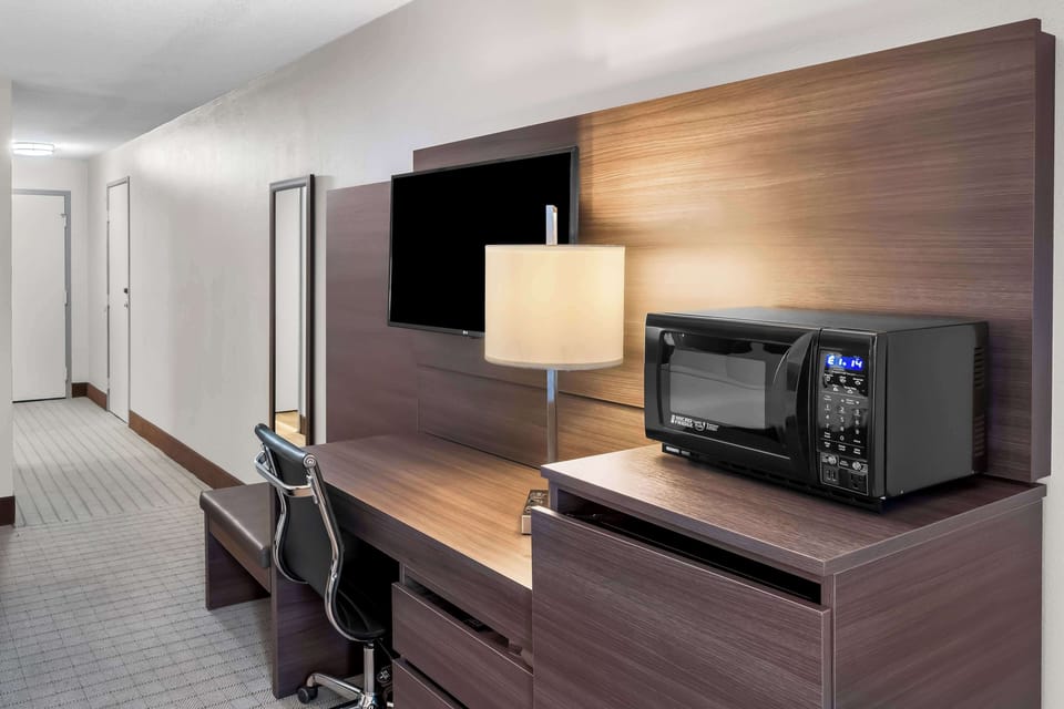 Hypo-allergenic bedding, desk, laptop workspace, blackout drapes