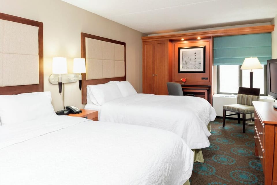 Premium bedding, desk, laptop workspace, blackout drapes