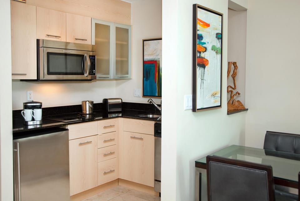 Suite, 1 King Bed, Balcony, City View | Private kitchen | Fridge, microwave, stovetop, dishwasher