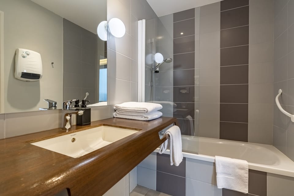 Bathroom | Bathtub, hair dryer, towels, soap