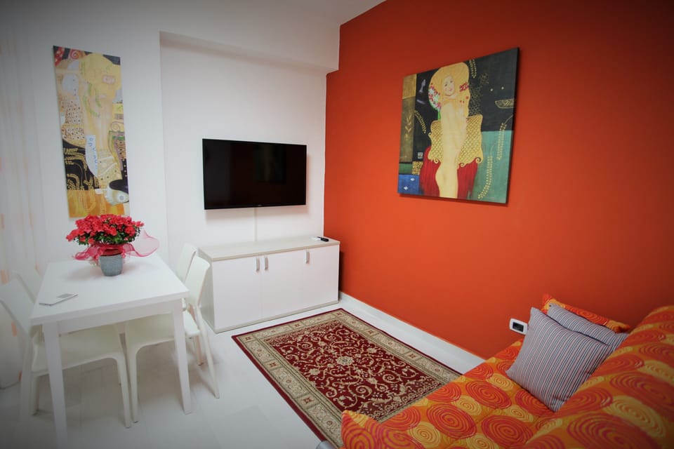 Deluxe Apartment, 1 Bedroom | Living area | 50-inch LED TV with digital channels, TV, first-run movies