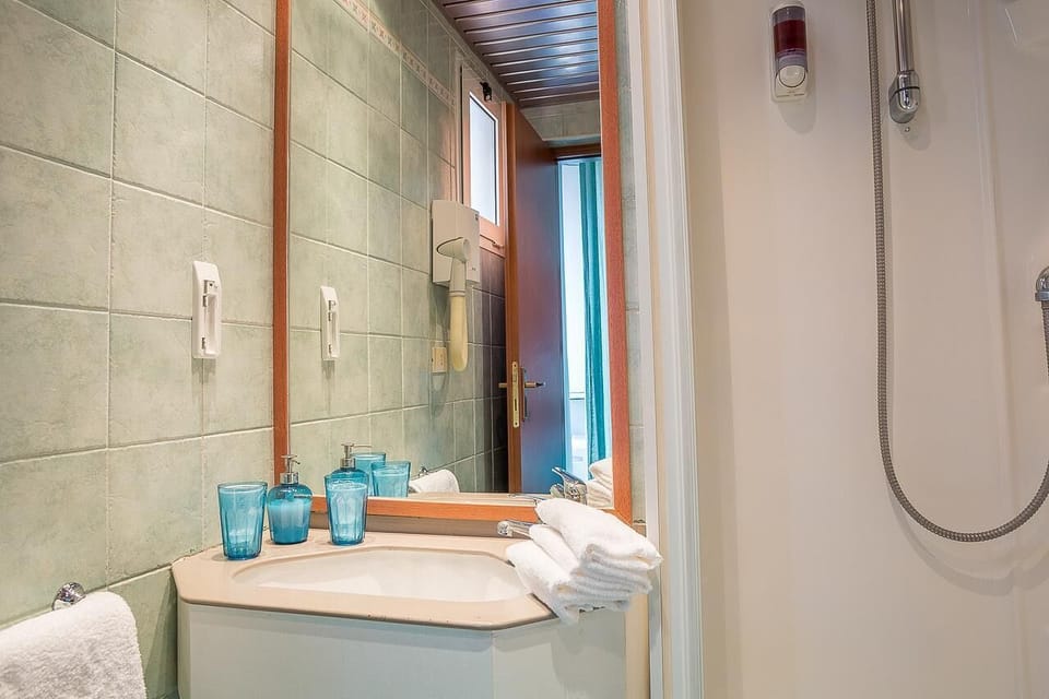 Shower, hair dryer, slippers, towels