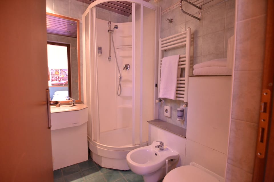 Shower, hair dryer, slippers, towels