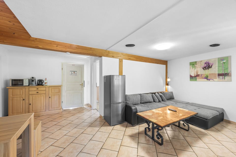 Apartment, 2 Bedrooms | Living area | 32-inch TV with cable channels
