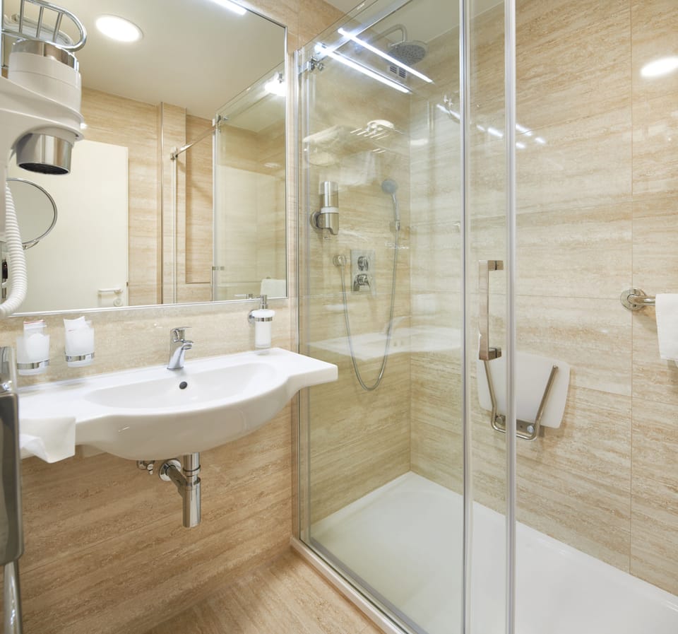 Designer toiletries, hair dryer, slippers, towels
