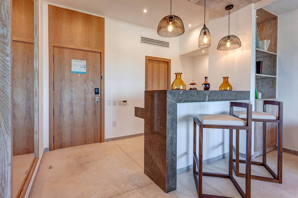 Presidential Ocean Front One Bedroom Suite | Minibar, in-room safe, blackout drapes, iron/ironing board