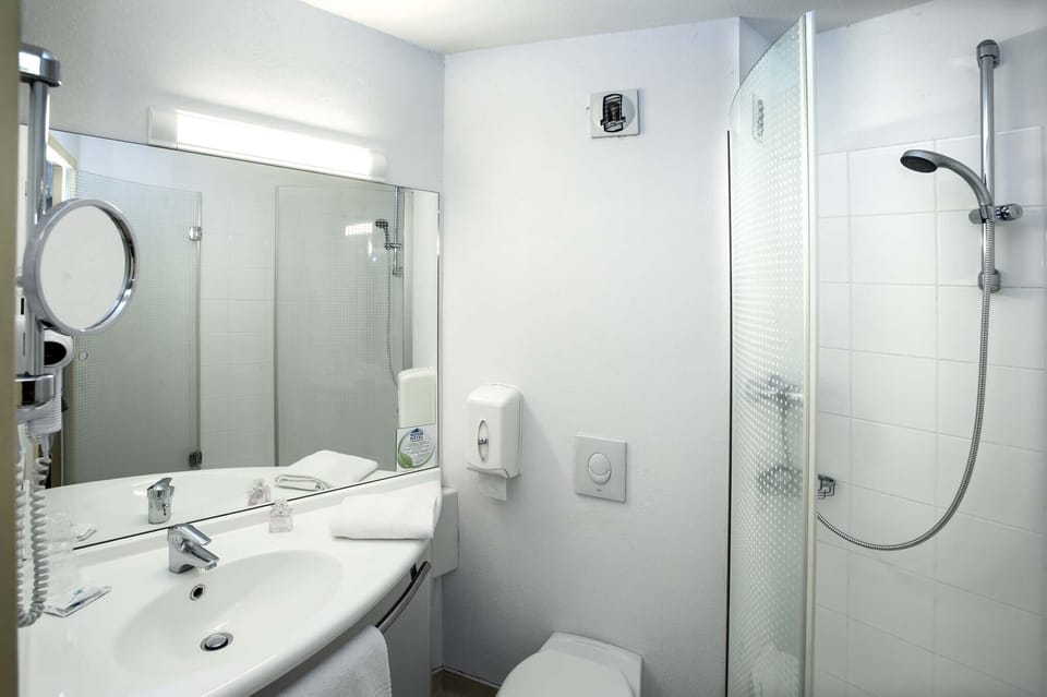 Shower, rainfall showerhead, hair dryer, towels