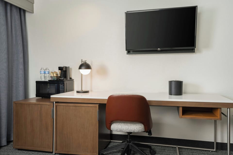 Premium bedding, desk, laptop workspace, iron/ironing board