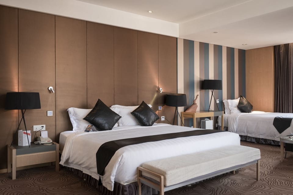 Deluxe Family Room | Hypo-allergenic bedding available, down comforters, minibar