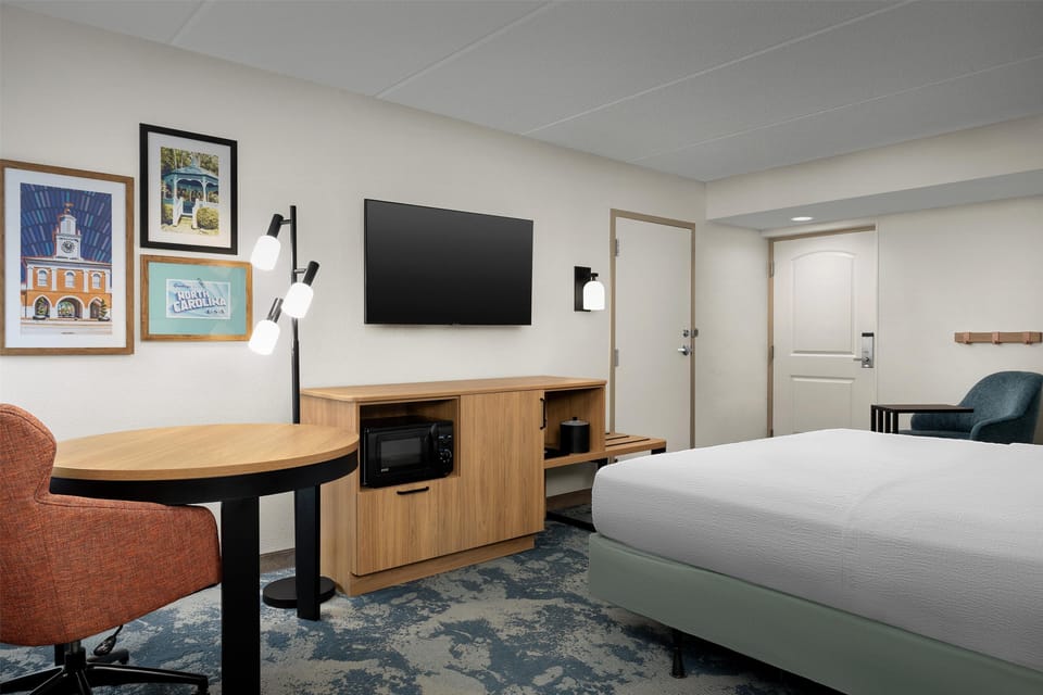 Premium bedding, desk, laptop workspace, blackout drapes