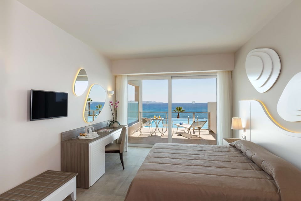 Family Room, Pool Access, Sea View (Executive) | Free minibar, in-room safe, desk, blackout drapes
