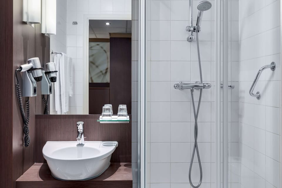 Deep soaking tub, rainfall showerhead, eco-friendly toiletries