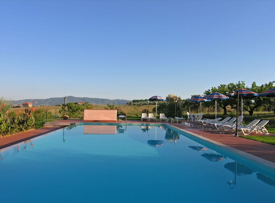 Outdoor pool, open 8 AM to 7 PM, pool umbrellas, sun loungers
