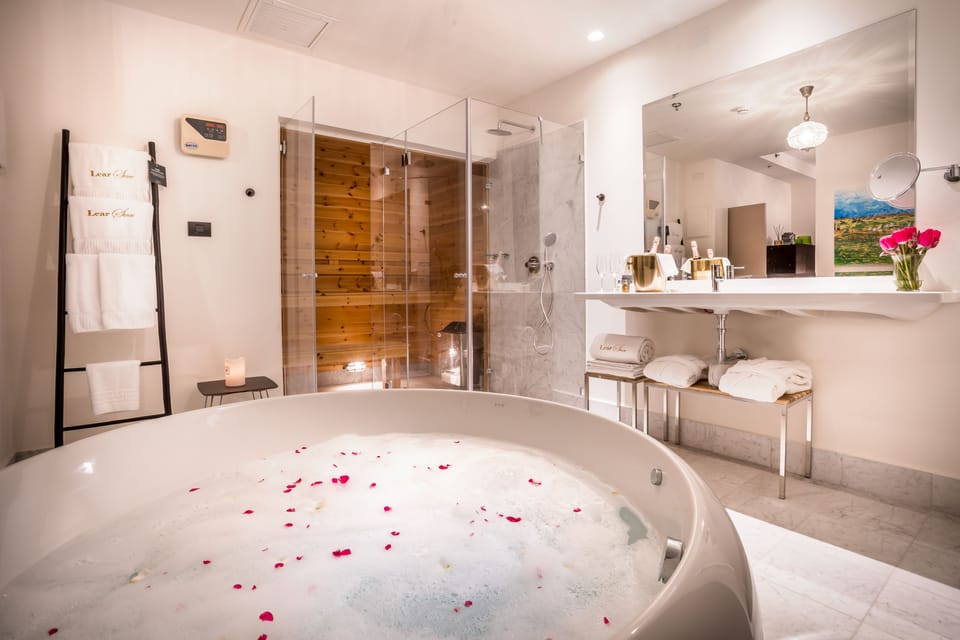 Deluxe Suite | Bathroom | Designer toiletries, hair dryer, bathrobes, slippers