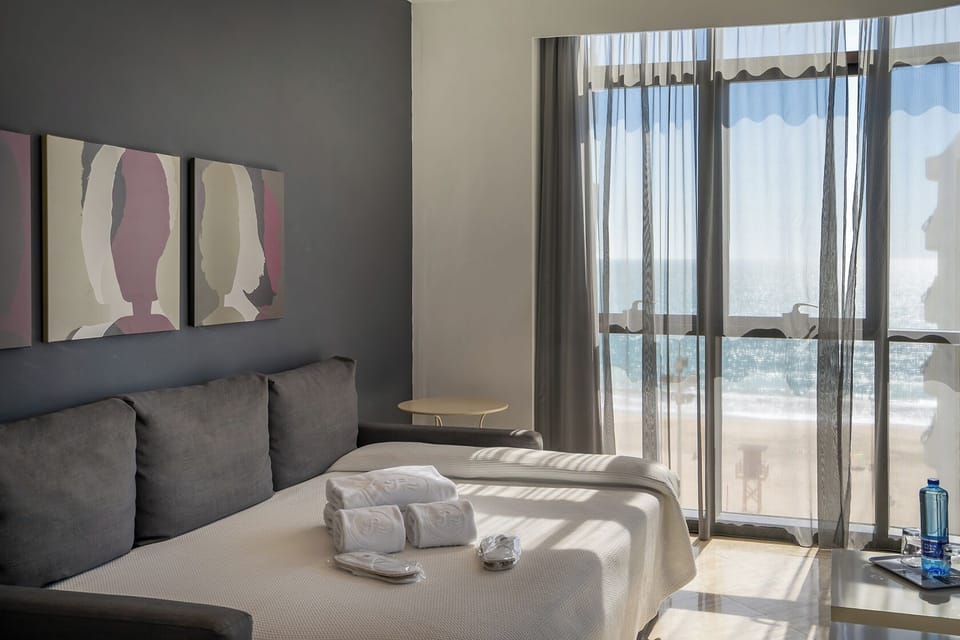 Apartment, 1 Bedroom, Sea View | 1 bedroom, down comforters, minibar, in-room safe