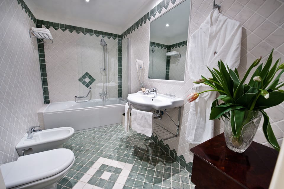 Family Triple Room | Minibar, in-room safe, desk, blackout drapes