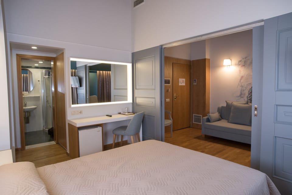 Executive Triple Room | Minibar, in-room safe, desk, soundproofing