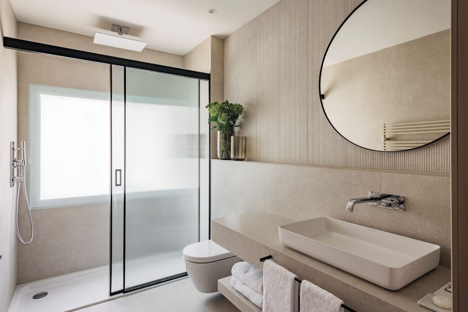 Designer toiletries, hair dryer, slippers, towels
