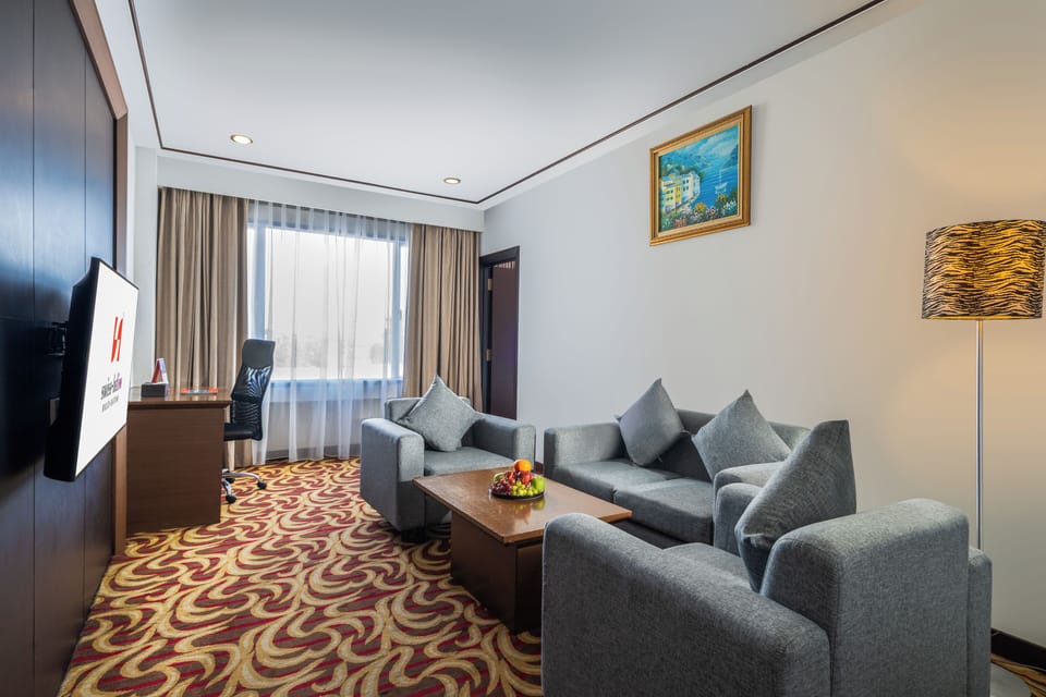 Suite, 1 Queen Bed | Living area | 21-inch LCD TV with cable channels, TV