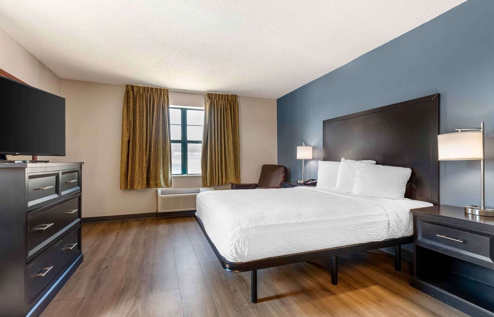 Desk, laptop workspace, blackout drapes, iron/ironing board