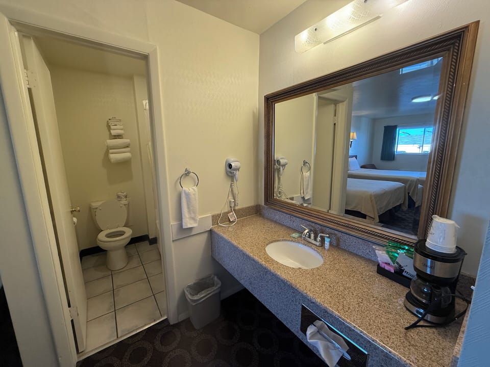 Standard Double Room, 2 Queen Beds | Bathroom | Combined shower/tub, free toiletries, hair dryer, towels