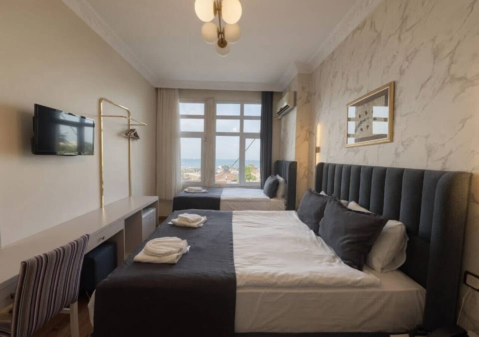 Deluxe Triple Room, Sea View | Premium bedding, pillowtop beds, minibar, in-room safe