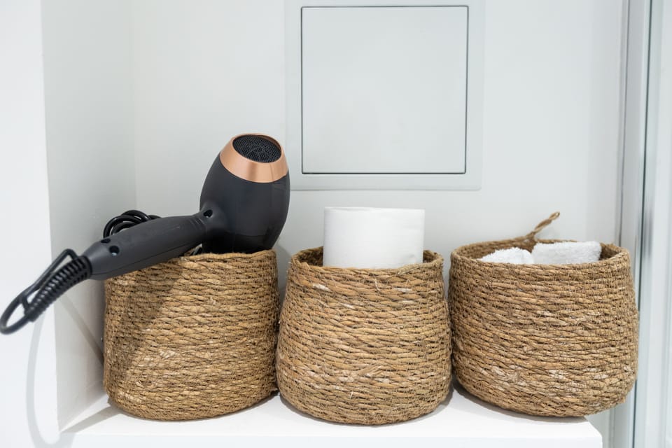 Shower, hair dryer, slippers, towels