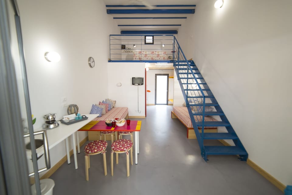 Family Quadruple Room | Living area | Flat-screen TV