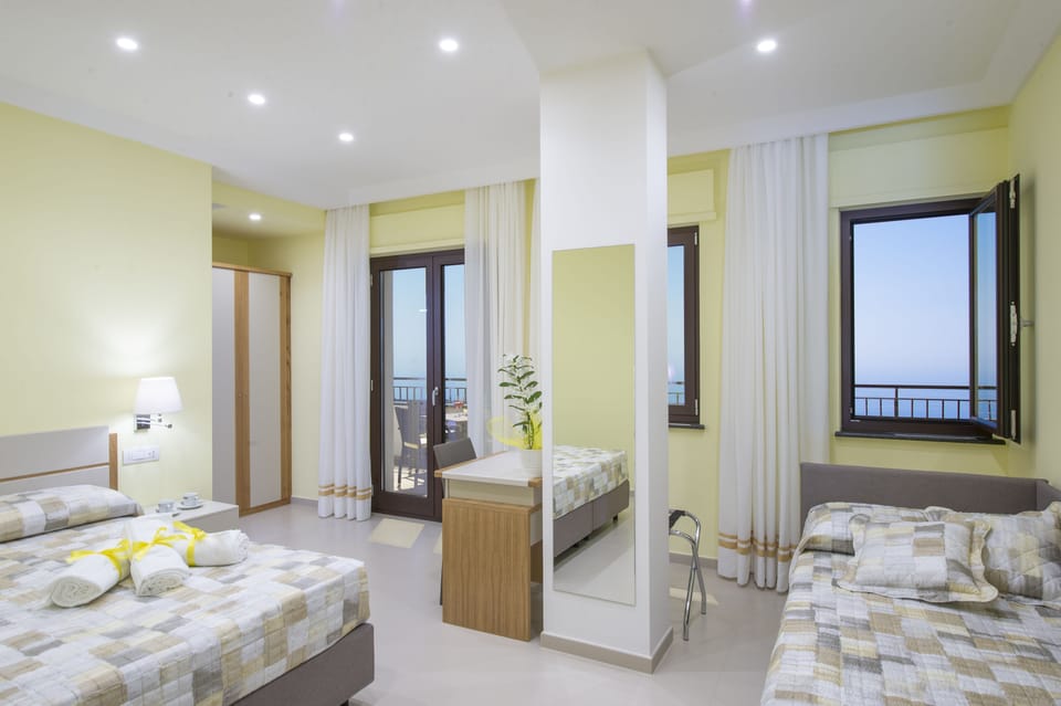 Luxury Triple Room | Minibar, individually decorated, individually furnished, desk