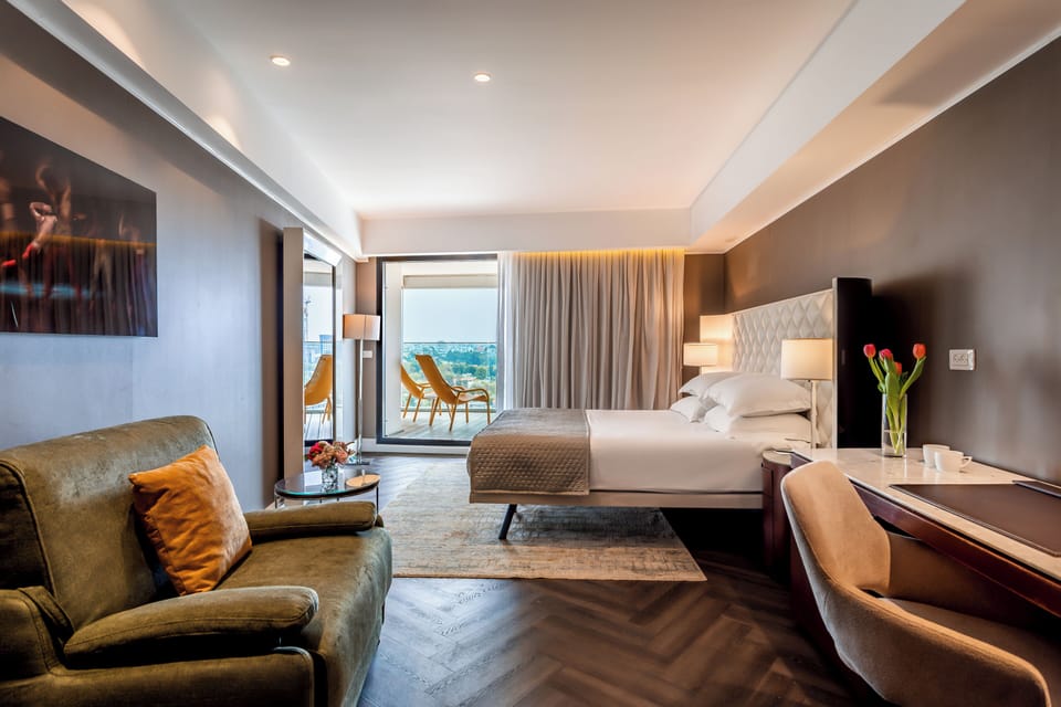 Deluxe Double Room, Balcony, City View | Minibar, in-room safe, blackout drapes, soundproofing