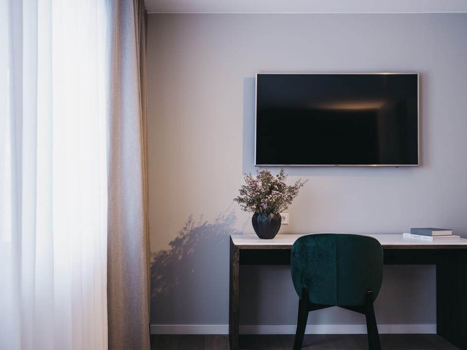 Standard Room | Living area | 32-inch LCD TV with digital channels, TV, books