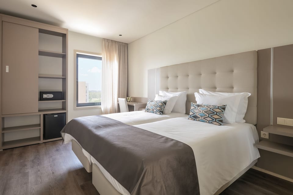 Standard Twin Room | Minibar, in-room safe, desk, blackout drapes
