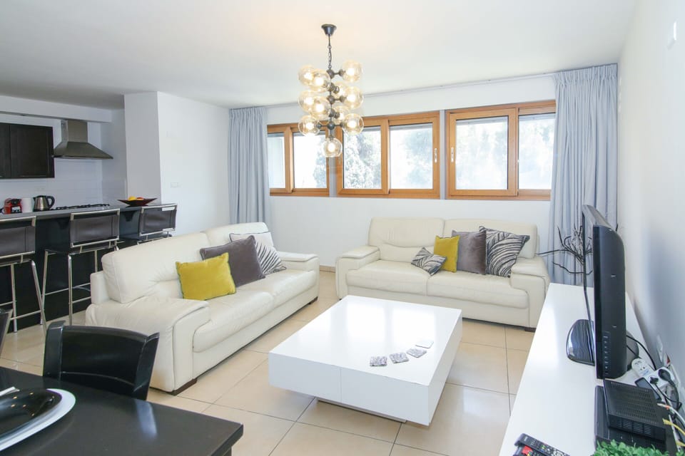 Luxury Apartment (104), 3 bedrooms, 1 living room | Living area | 50-cm flat-screen TV with cable channels, TV