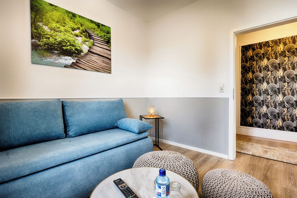 Comfort Quadruple Room | Living area | 70-cm LCD TV with cable channels, TV