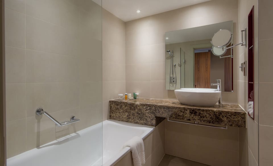 Shower, designer toiletries, hair dryer, towels