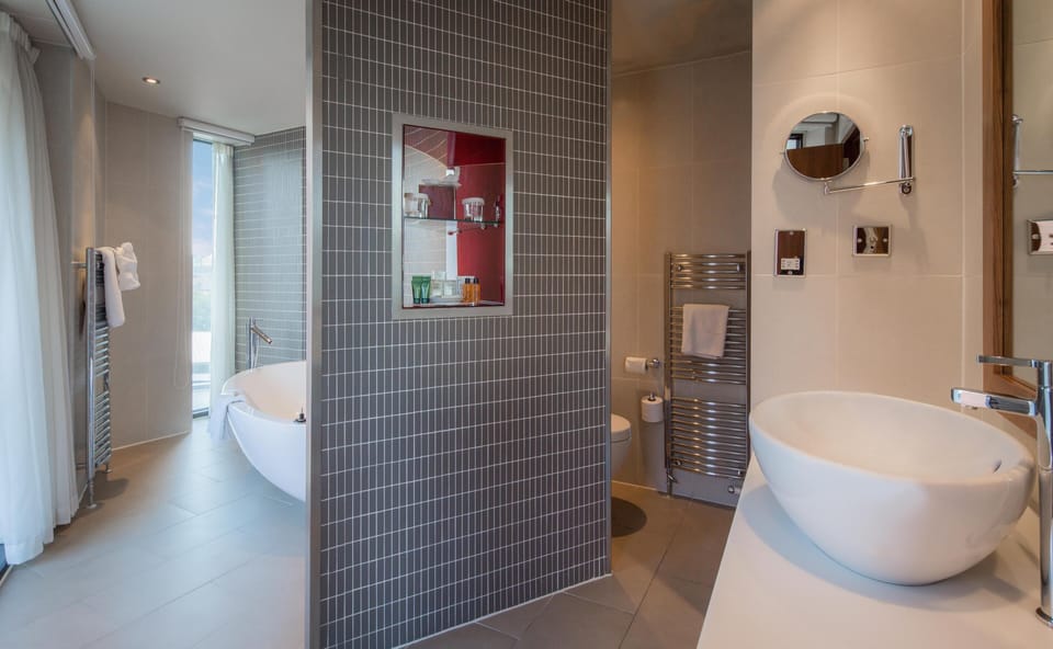 Suite, Corner (King) | Bathroom | Shower, designer toiletries, hair dryer, towels