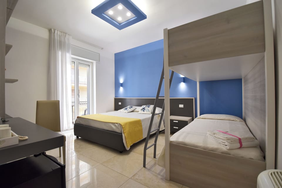 Family Room | Memory foam beds, minibar, in-room safe, desk