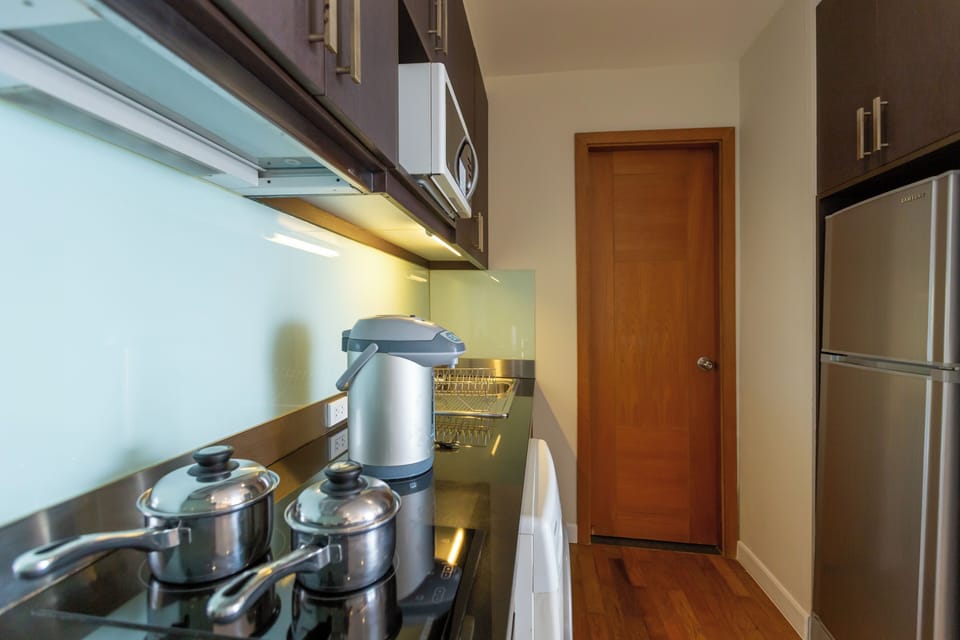  One Bedroom Suite | Private kitchen | Coffee/tea maker, full-size fridge, microwave, stovetop