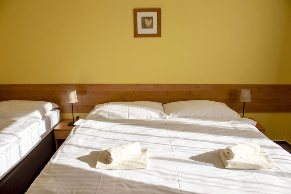 Triple Room | Desk, blackout drapes, cribs/infant beds, rollaway beds