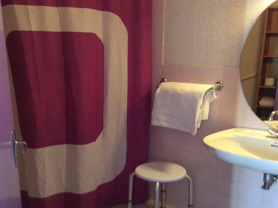 Shower, hair dryer, slippers, towels