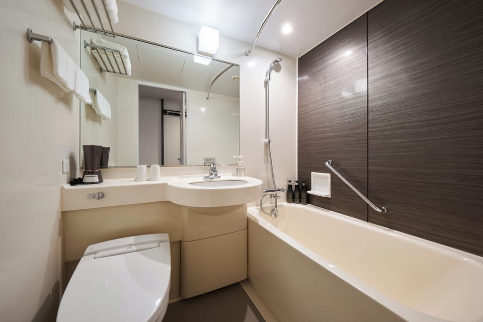 Combined shower/tub, free toiletries, hair dryer, slippers
